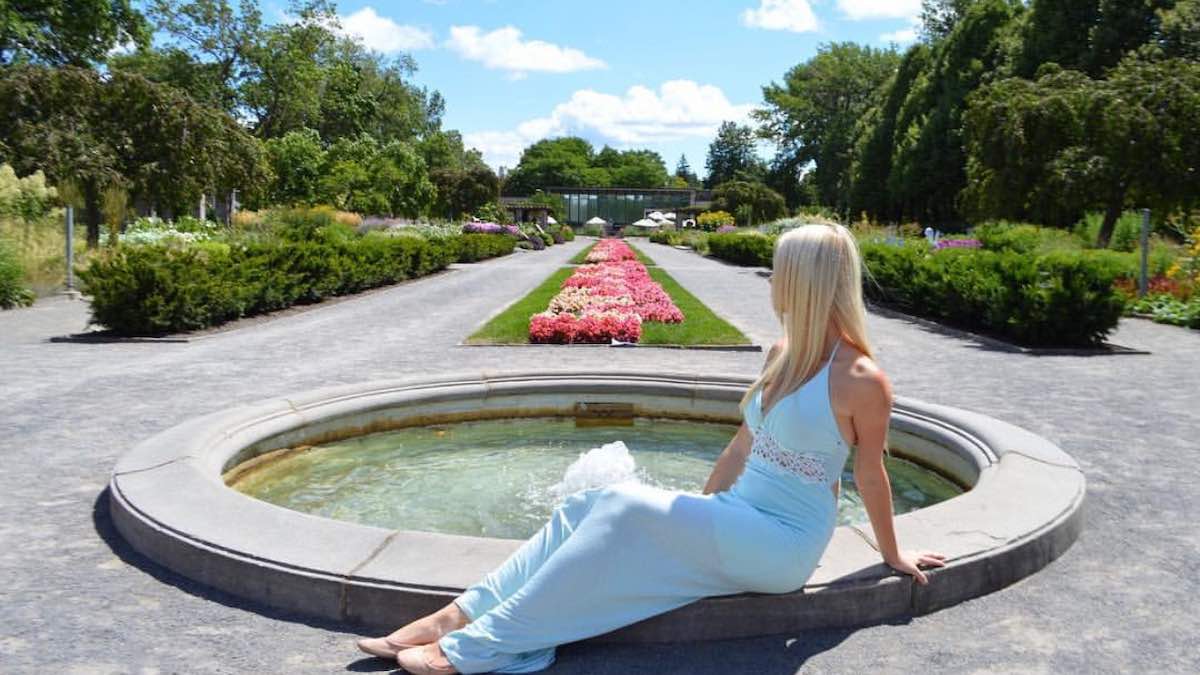 Cheyanne Herrera sitting in front of a fountain in Montreal's Botanical Garden.